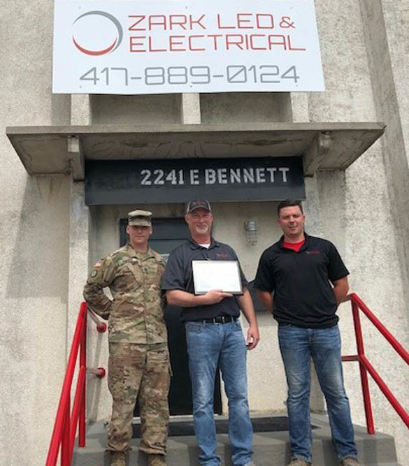 Patriotic Support
Ozark LED & Electrical General Manager Shawn Killion, center, receives a Patriot Award on July 3 from Cpt. Tim Porter, a presenter with Employer Support of the Guard and Reserve. Electrician and crew lead Drake Leith, at right, nominated Killion for the award, which recognizes support of employees and family members of those who serve in the National Guard and reserves. Leith serves as a sergeant assigned to 276 Engineer Co., 203rd Engineer Battalion of the Missouri Army National Guard in Pierce City. He was deployed in 2014 to Afghanistan.